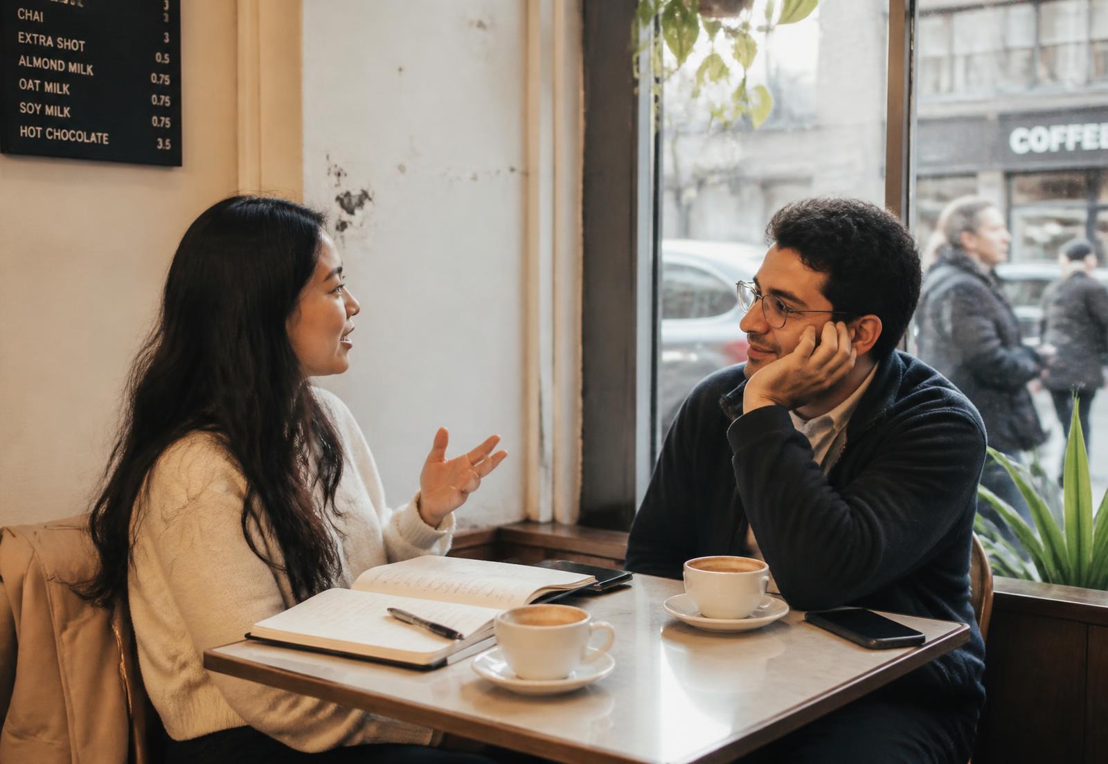 Two colleagues in a mentorship conversation over coffee in New York